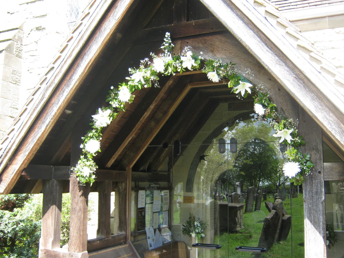 The lych gate at St James, dressed with flowers for a wedding